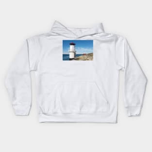 a sailboat passes the lighthouse Kids Hoodie